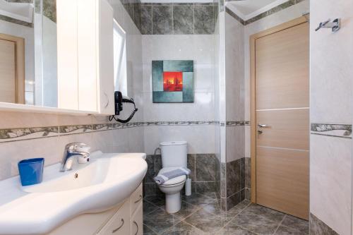a bathroom with a sink and a toilet at Vasso Apartments 3 in Kissamos