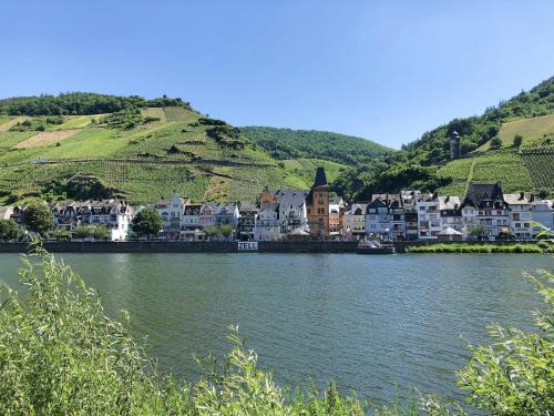 a river with a town in the middle of a city at MaximilianHaus in Zell an der Mosel