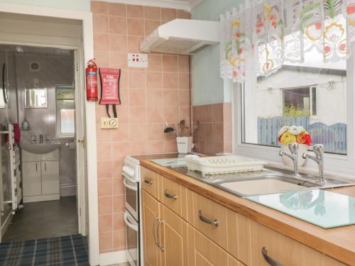 a kitchen with a sink and a shower at Sandpiper in Dumfries