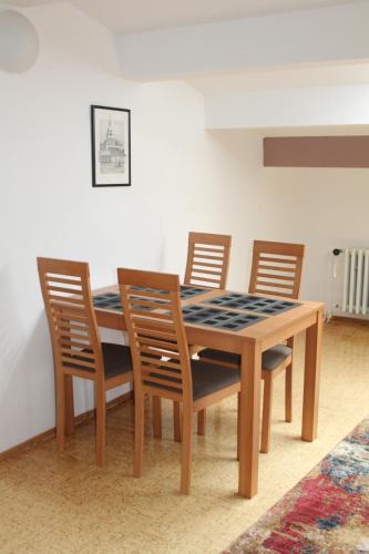 a dining room table with four chairs and a table and a table and chairsktop at Ubytovanie v súkromí Nová Baňa in Nová Baňa