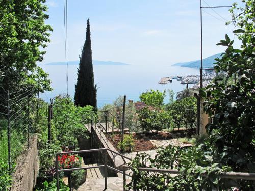 a stairway in a garden with a view of the ocean at Apartment Hela - LOV512 by Interhome in Opatija