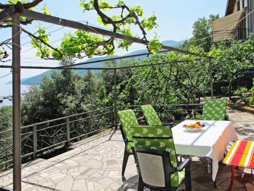 a table and chairs on a patio with a view at Apartment Hela - LOV512 by Interhome in Opatija