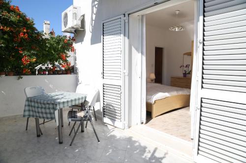 a small balcony with a table and a bed at Apartments Butkovic in Hvar
