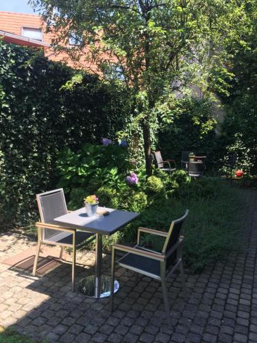 a table and two chairs on a patio at Gábriel Apartman in Kőszeg