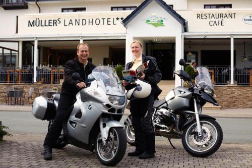 a man and a woman sitting on a motorcycle at Müllers Landhotel in Medebach