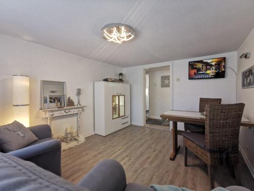 a living room with a table and a couch at FeWo Hage in Langelsheim