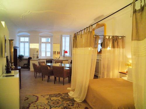 a bedroom with a bed and a dining room at Hotel Goldenes Kreuz in Regensburg
