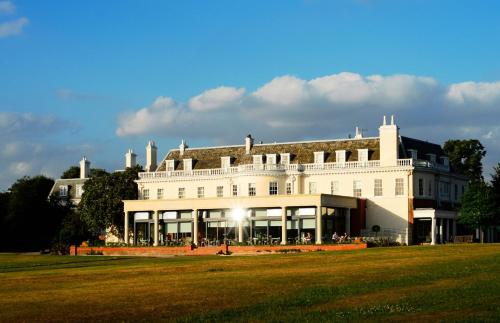 a large white building on a grass field at Hotel du Vin Cannizaro House Wimbledon in London