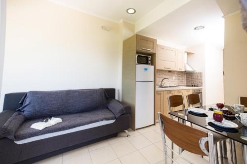 a living room with a couch and a kitchen at Vasso Apartments 3 in Kissamos