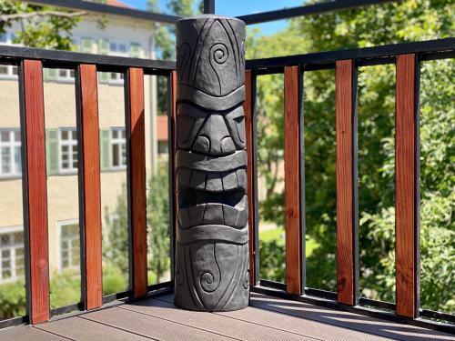 a totem pole sitting on a balcony at Altstadt Apartments in Kirchheim unter Teck