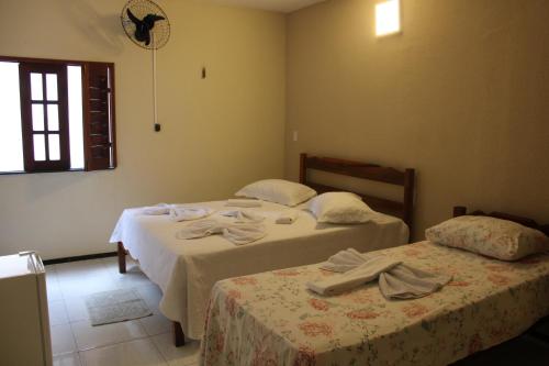 Katil atau katil-katil dalam bilik di HOTEL CANTINHO DAS FLORES