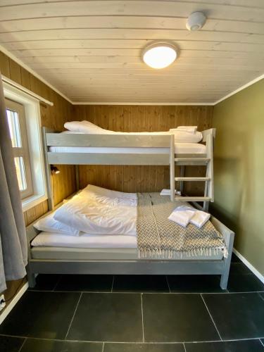 a bedroom with two bunk beds in a room at Korgfjellet Fjellstue as in Korgen