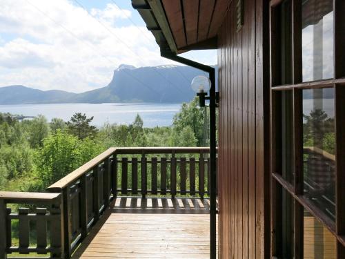 a balcony with a view of a lake and mountains at Holiday Home Fjordperlen - FJS145 by Interhome in Sørbø