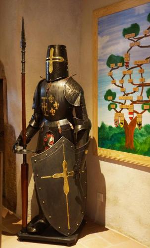 a statue of a knight in armour next to a painting at Au Nid de Cigogne in Zellenberg