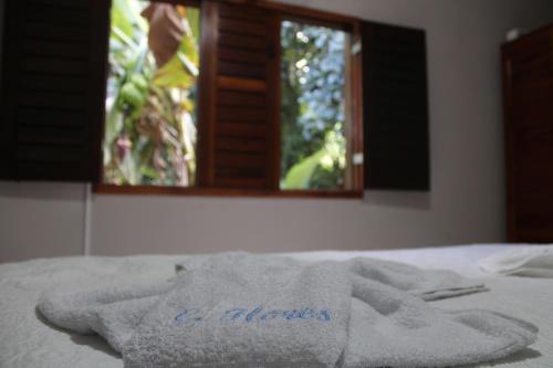 Katil atau katil-katil dalam bilik di HOTEL CANTINHO DAS FLORES