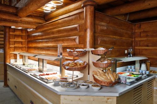 a buffet with bread and other food on a table at Rezort Gothal Apartmány a Penzióny in Donovaly