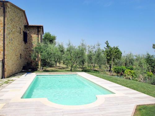 a swimming pool in a yard next to a building at Holiday Home Rustico Cavernoso by Interhome in Colle Val D'Elsa