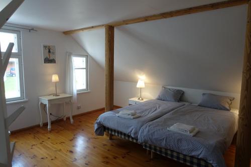 a bedroom with a bed with two tables and two lamps at Villa Elisabeth Apartments in Pärnu