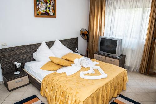 a hotel room with a bed with towels on it at Club Residence Apartments in Neptun