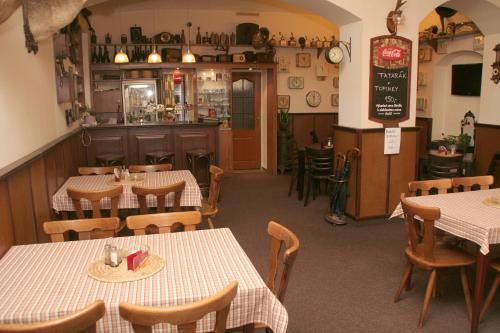 a restaurant with tables and chairs and a bar at Penzion Aladdin in Teplice