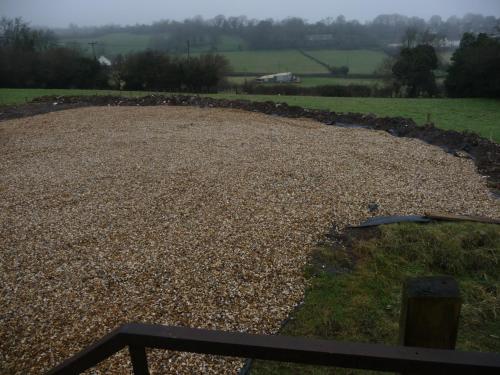 a large gravel field with a stone wall at Hillcrest Farm Bed & Breakfast in Redhill