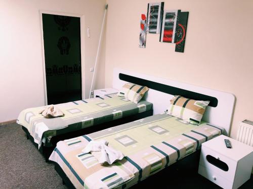 two beds sitting next to each other in a room at Hotel and Entertaiment Complex Vlada in Cherkasy