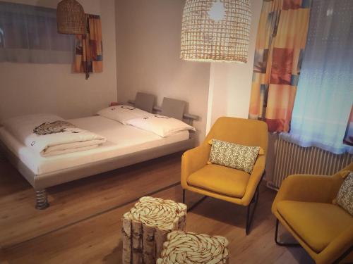 1 dormitorio pequeño con 1 cama y 1 silla en Motel - Hôtel "Inter-Alp" à St-Maurice, en Saint-Maurice