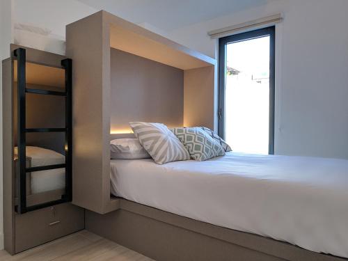 a bedroom with a bunk bed and a window at Broz Hostel in Granada