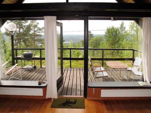 a screened in porch with chairs and a grill at Chalet Lofsdalen Fjällbjörken - HJD054 by Interhome in Lofsdalen