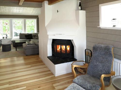 a living room with a fireplace in a house at Chalet Kvisthån Idegranen - HJD059 by Interhome in Vemhån