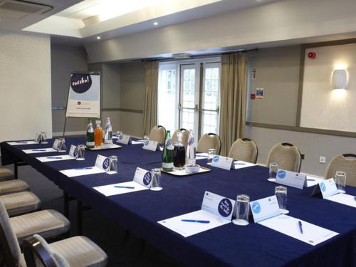 a conference room with a long table and chairs at Buchanan Arms Hotel & Leisure, Sure Hotel Collection in Drymen