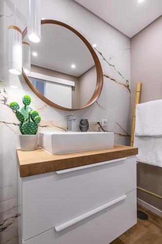 a bathroom with a sink and a mirror at Kerala 49, Deluxe Flat in Historic Center in Peniche