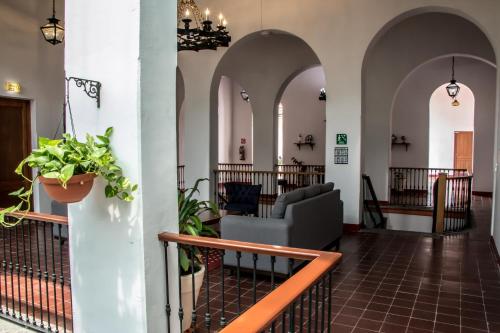 a lobby of a building with arches and a couch at Hotel Real de Castilla Colonial in Guadalajara