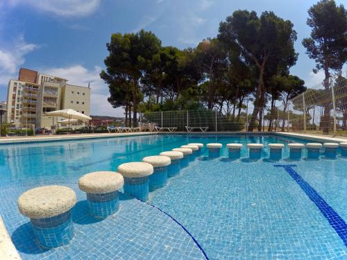 une grande piscine avec tabourets dans l'eau dans l'établissement Trill Mirasol C primera linea mar L'Estartit, à L'Estartit