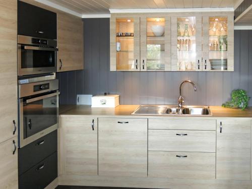 a kitchen with a sink and a microwave at Chalet Doghouse by Interhome in Øyuvstad