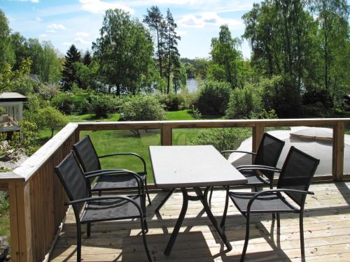a patio with a table and chairs on a deck at Holiday Home Munkhalla Morgonsolen by Interhome in Asarum