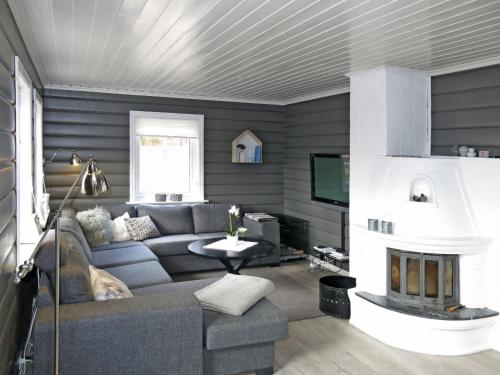 a living room with a couch and a fireplace at Chalet Kosekroken - SOW081 by Interhome in Fossdal