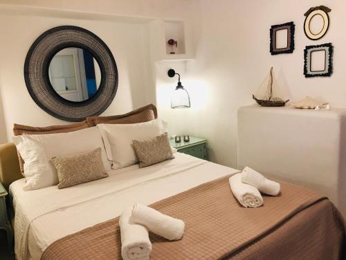 a bedroom with a large bed with towels on it at Klaras House in Platis Yialos Mykonos