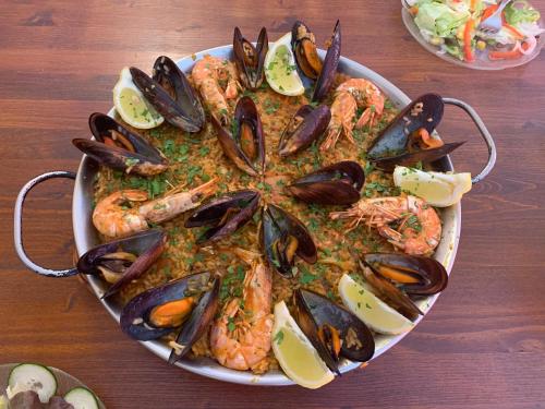 a plate of shrimp and mussels on a table at Pension Casa Austria in Calella