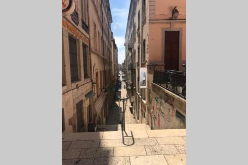 an empty alley with buildings in a city at Appartement entier - refait à neuf - Loft - City Center in Lyon