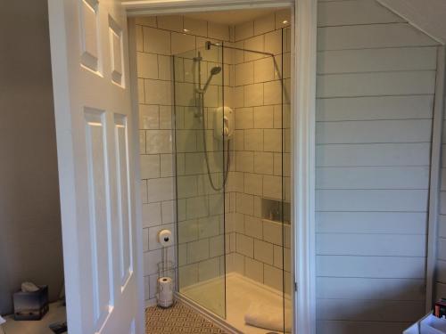 a shower in a bathroom with a glass shower stall at Number Ninety One in Eastbourne