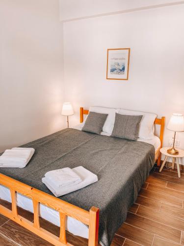a bedroom with a large bed with two towels on it at Cozy place in Larnaka