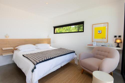 une chambre avec un lit, une chaise et une fenêtre dans l'établissement Le Jas du Boeuf, à Cruis