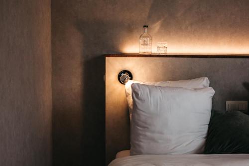a bedroom with a bed with a pillow and a lamp at Monsieur Maurice in Bruges