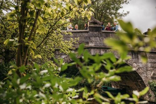 a group of people standing on top of a bridge at Monsieur Maurice in Bruges