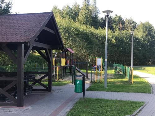 a park with a playground with a play area at Apartament Lemon in Pruszcz Gdański