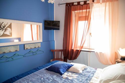 a bedroom with a bed and a mirror and a window at Sogni d'oro in Alberobello