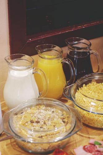 a table topped with glasses of milk and food at B&B Vila Tamaris in Zaječar