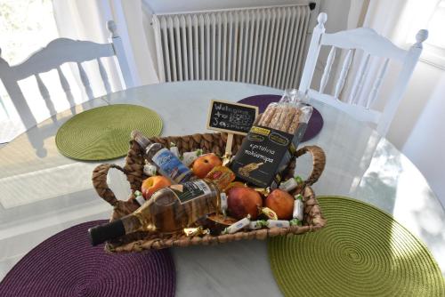 a basket of fruit and drinks on a table at jasmine apartments in Eretria