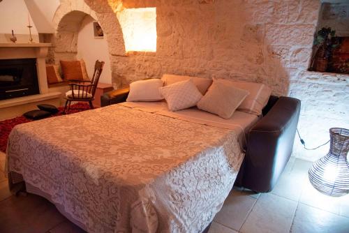 a bedroom with a bed in a room with a fireplace at Sogni d'oro in Alberobello